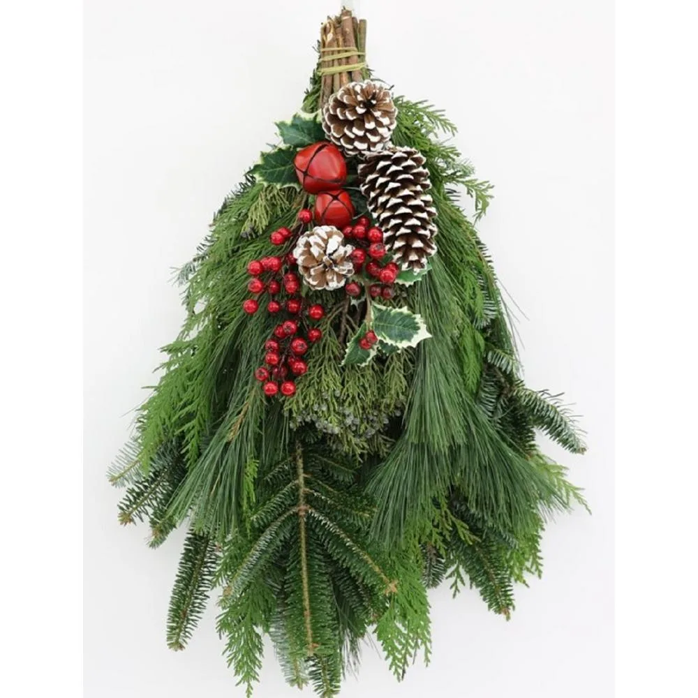 A fresh evergreen door swag with pinecones, red berries and a natural jute hanger